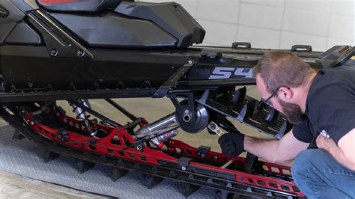 How do you adjust snowmobile ski pressure?