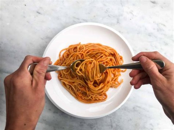Is it proper to eat spaghetti with a spoon?
