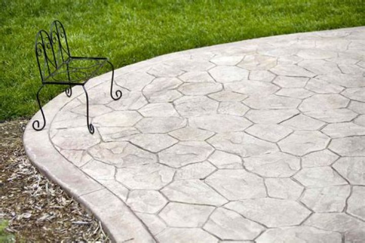 Is stamped concrete cheaper than tile?