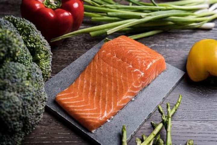 What do they feed farm-raised salmon?