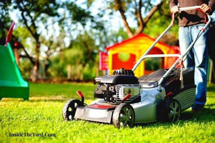 Why is my lawn mower spitting out grass?